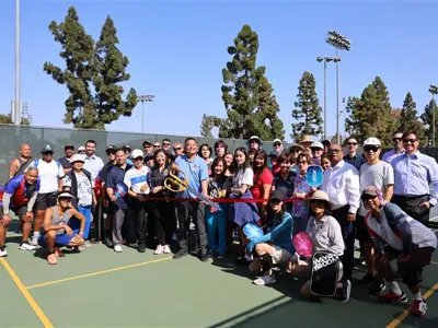 City staff and residents celebrate the opening of new pickleball courts in 2025.